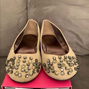 tan embellished flats.